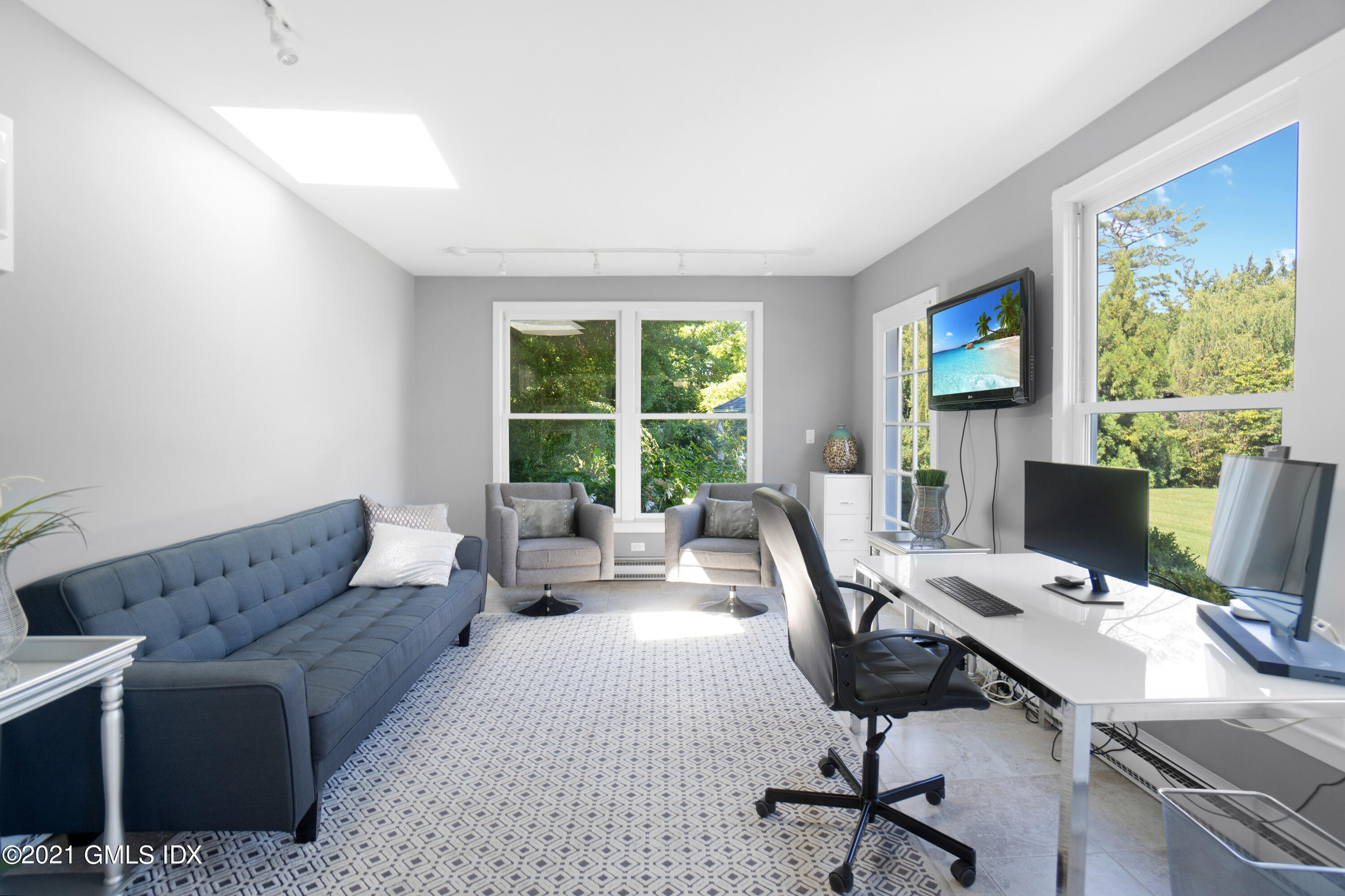 20 Ballwood Road Old Greenwich, CT 06870 - Photo 28 of 32 a living room with furniture floor to ceiling window and a flat screen tv