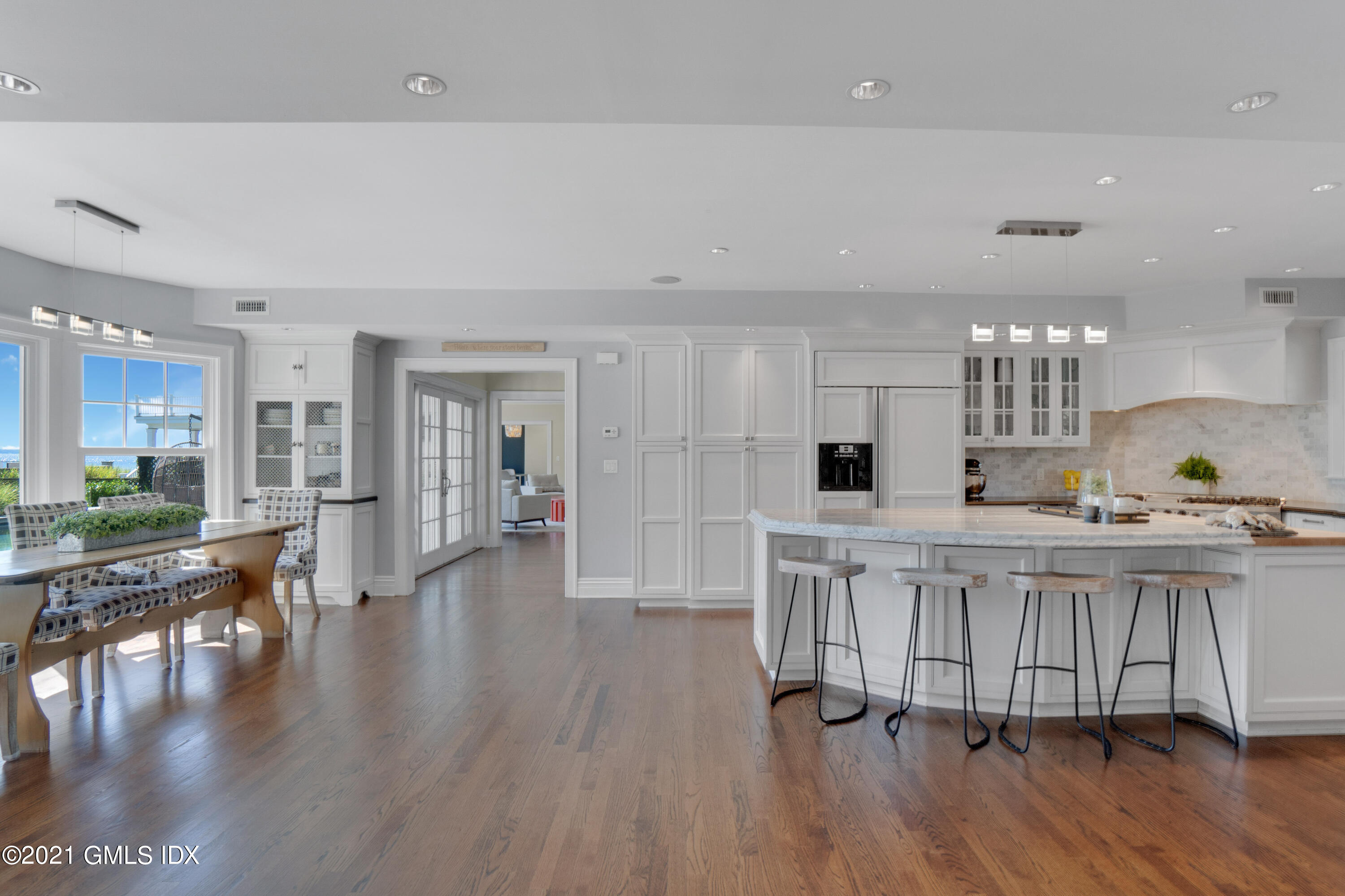 20 Ballwood Road Old Greenwich, CT 06870 - Photo 7 of 32 a kitchen with stainless steel appliances granite countertop a table chairs stove and white cabinets
