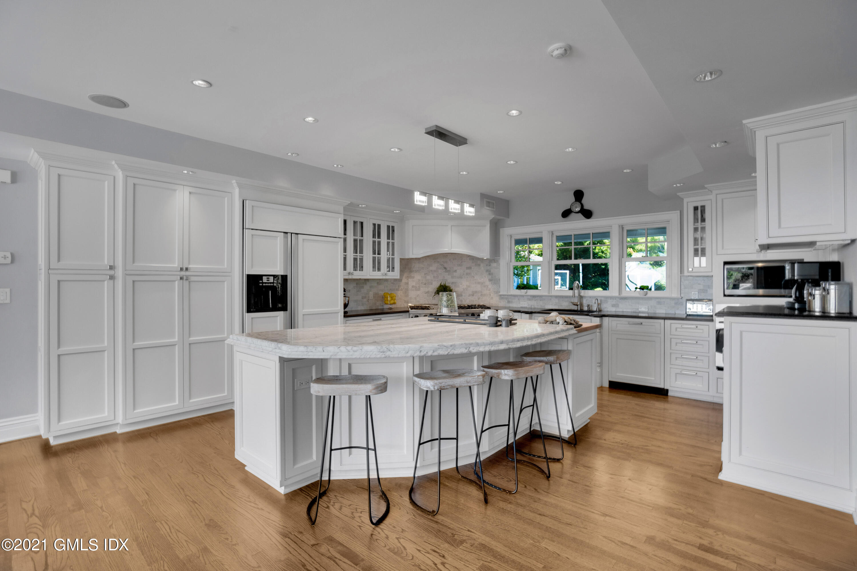 20 Ballwood Road Old Greenwich, CT 06870 - Photo 8 of 32 a kitchen with stainless steel appliances granite countertop a white cabinets and wooden floor