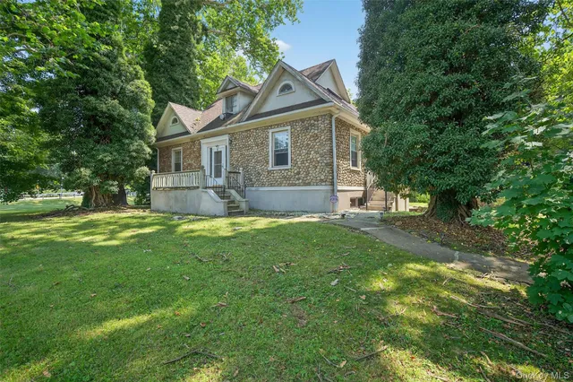a front view of house with yard and green space