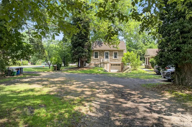 a view of a house with a tree in the background