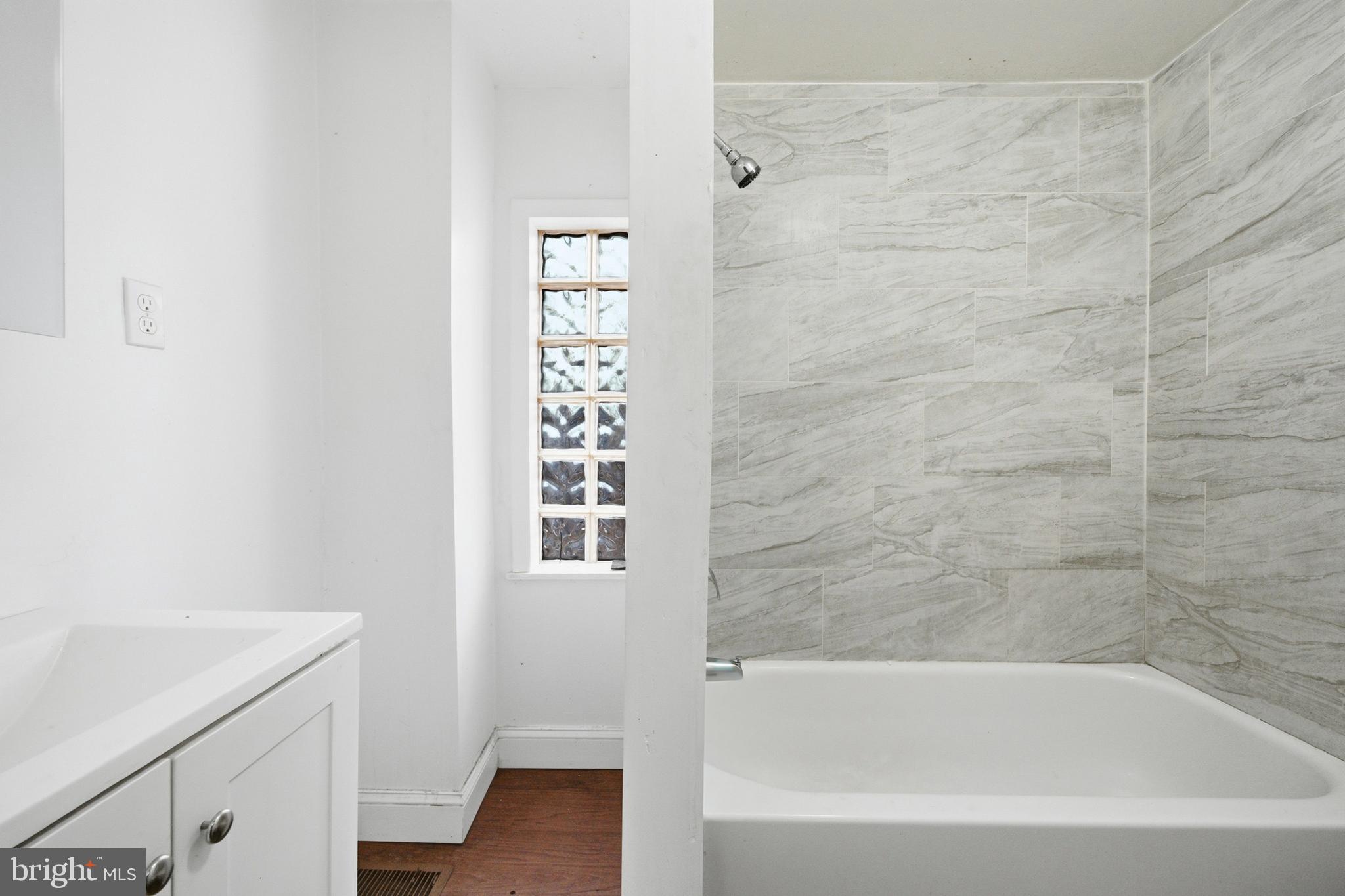 215 South Calhoun Street Baltimore, MD 21223 - Photo 11 of 15 a bathroom with a bathtub and shower