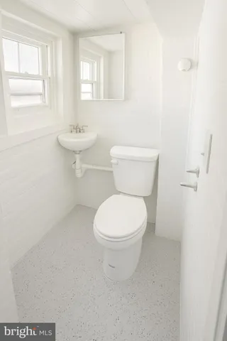 a white toilet sitting next to a bathroom sink