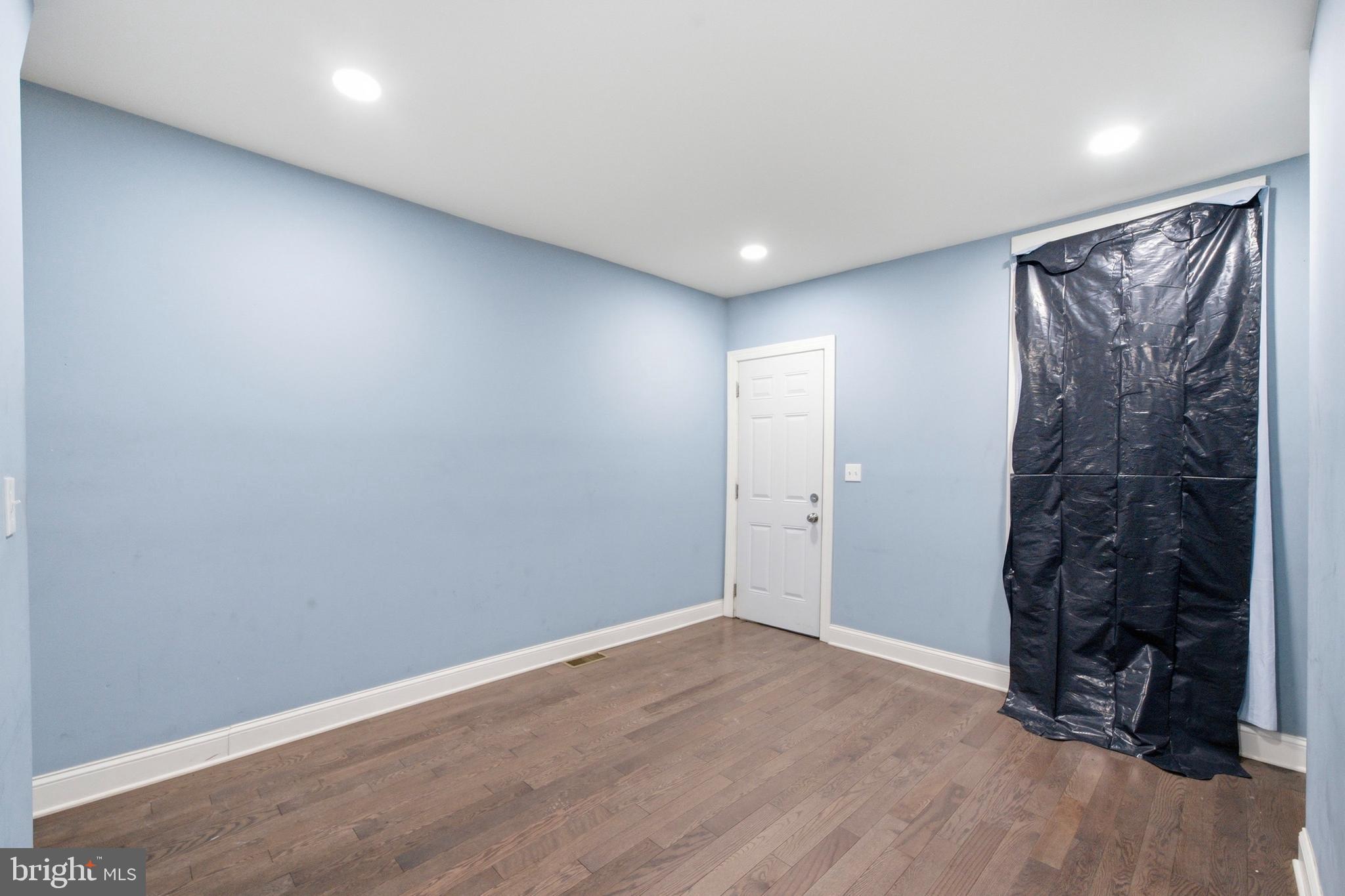 215 South Calhoun Street Baltimore, MD 21223 - Photo 2 of 15 wooden floor in an empty room