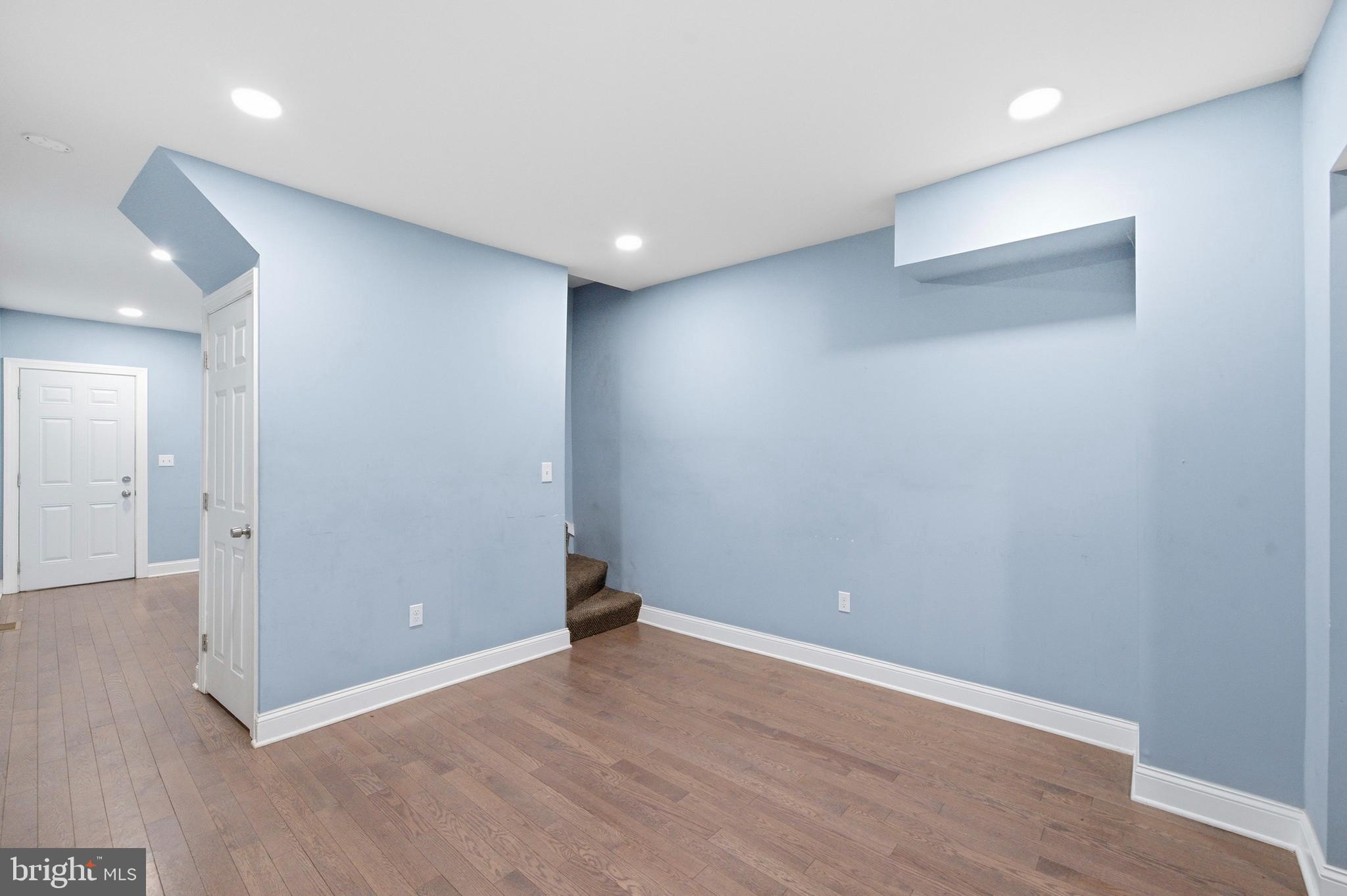 215 South Calhoun Street Baltimore, MD 21223 - Photo 5 of 15 wooden floor in an empty room