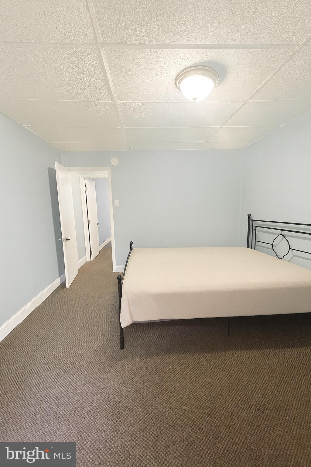 215 South Calhoun Street Baltimore, MD 21223 - Photo 8 of 15 a spacious bedroom with a bed and a table