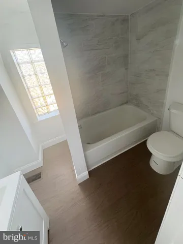 a bathroom with a toilet a sink and bathtub