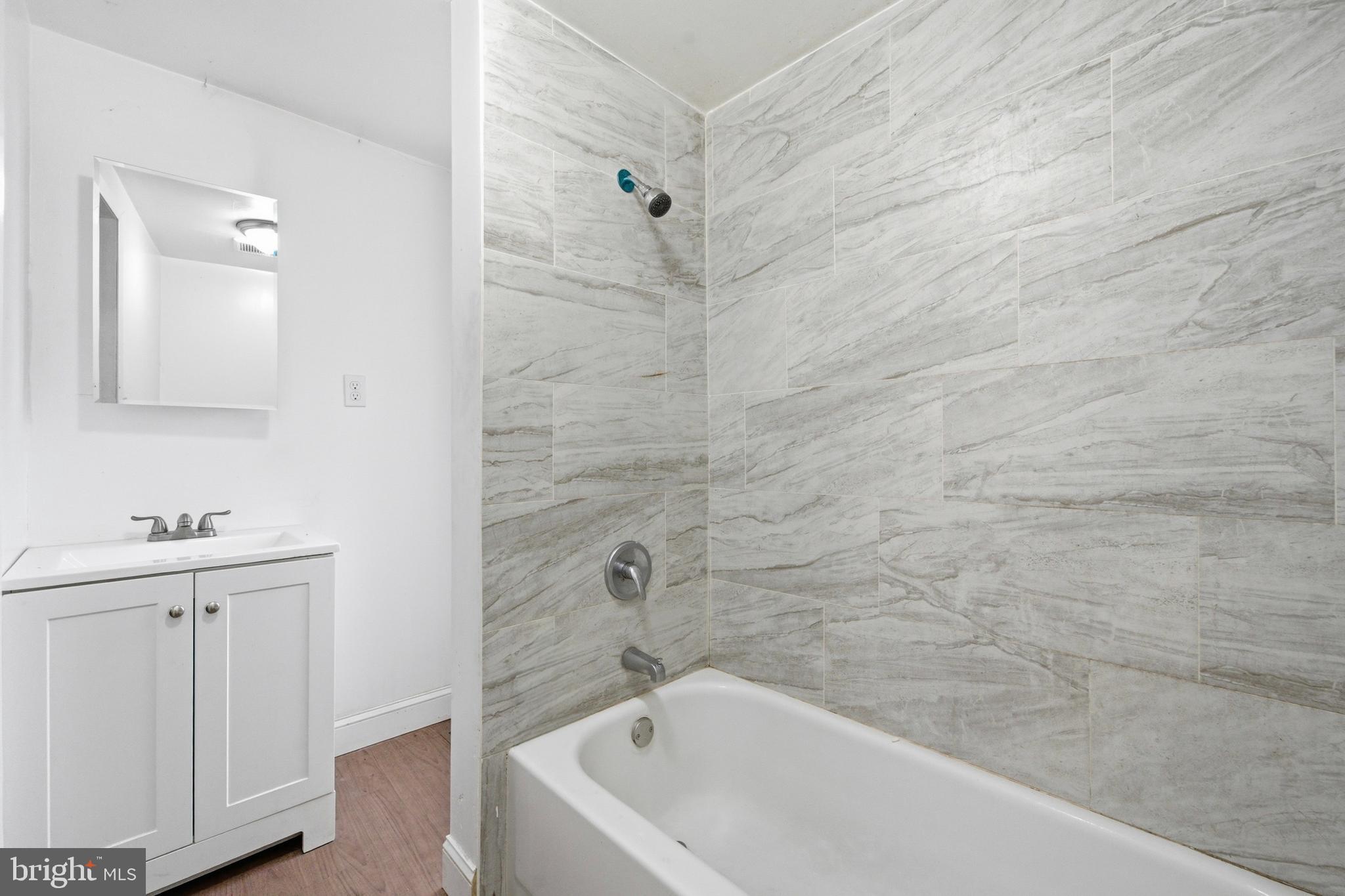 215 South Calhoun Street Baltimore, MD 21223 - Photo 10 of 15 a bathroom with a bathtub and a sink