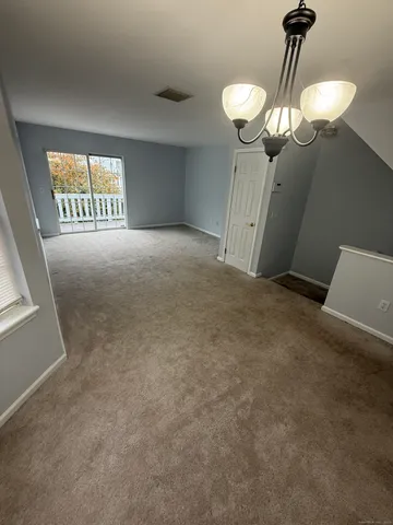 a view of empty room with a chandelier fan