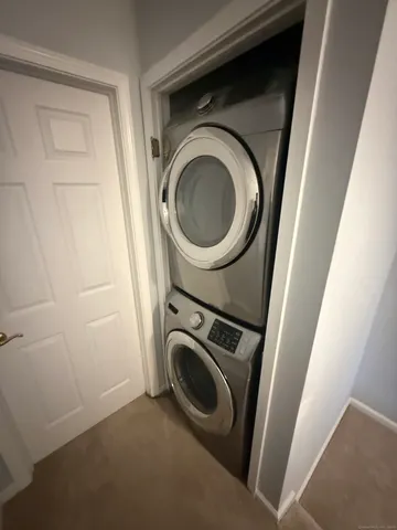 a bathroom with a granite countertop sink toilet and mirror