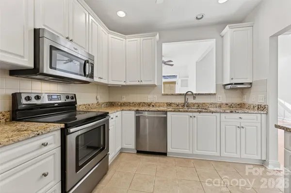 a kitchen with cabinets and a refrigerator