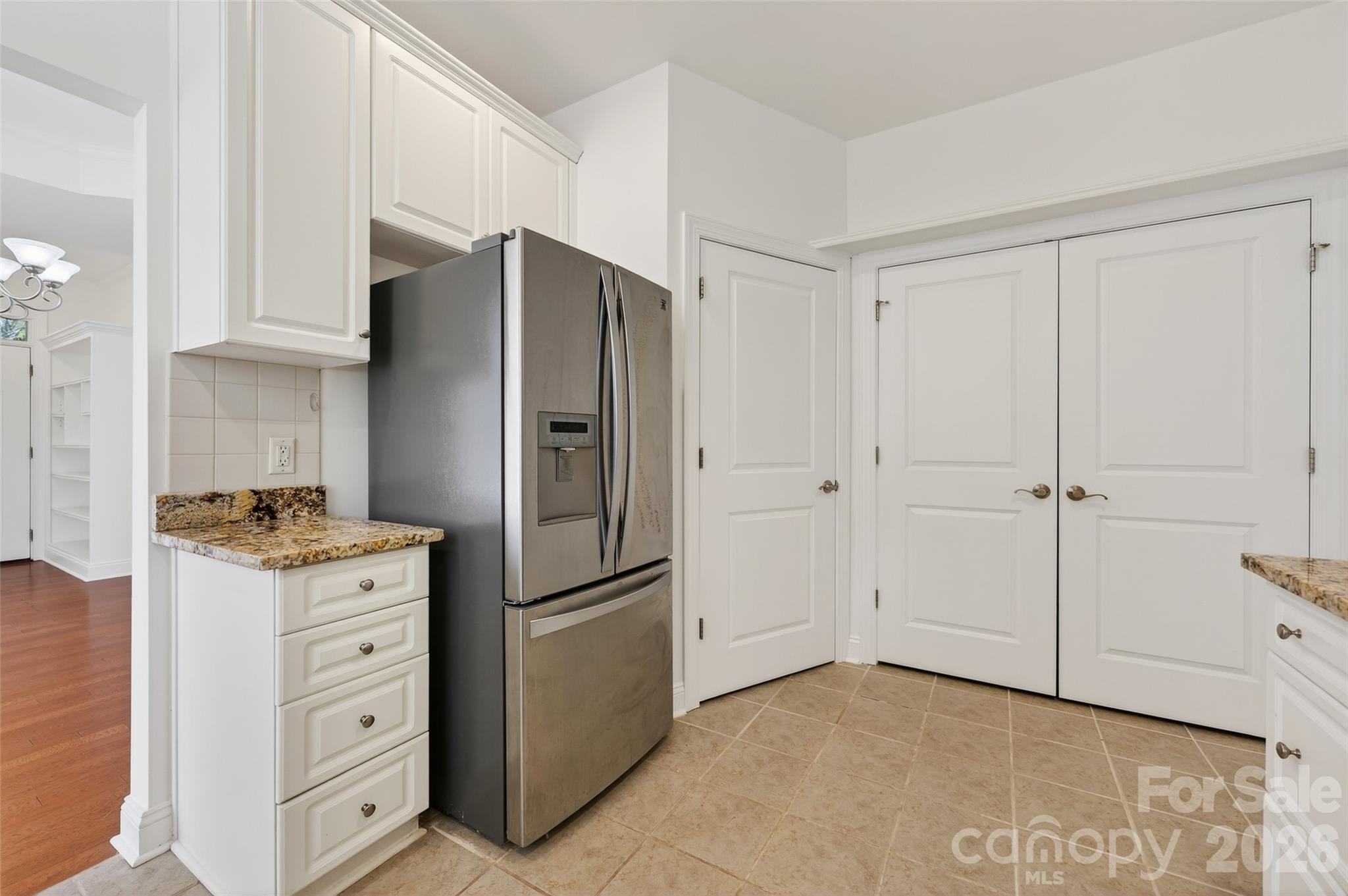 2803 Bellasera Way Matthews, NC 28105 - Photo 16 of 27 a kitchen with cabinets and a refrigerator