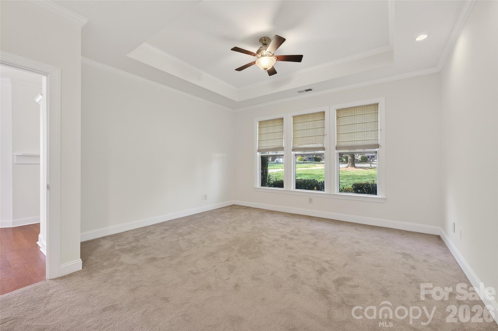 2803 Bellasera Way Matthews, NC 28105 - Photo 17 of 27 an empty room with windows and ceiling fan