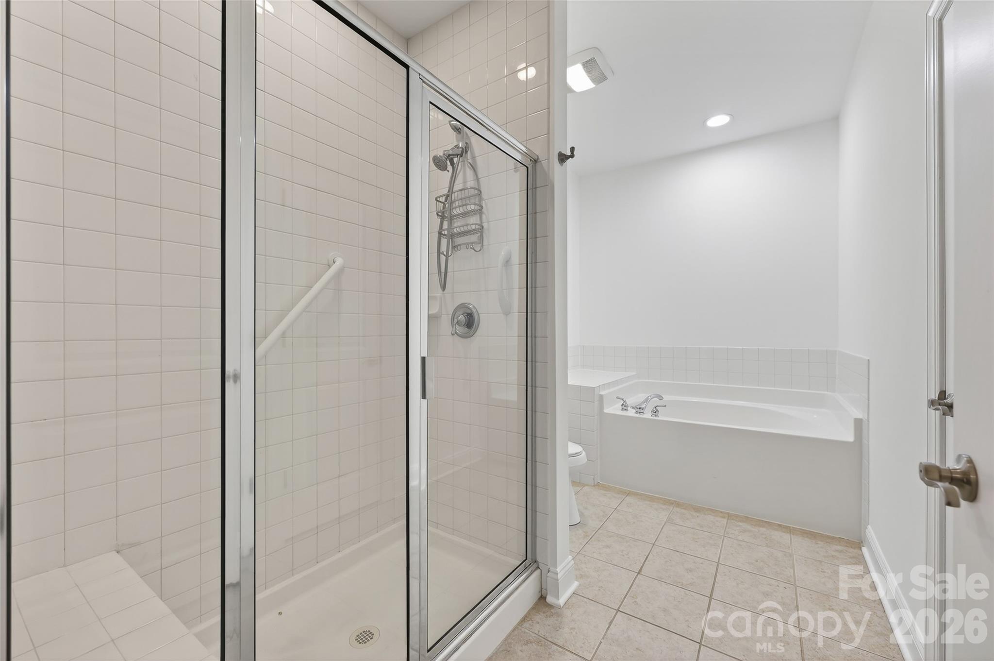 2803 Bellasera Way Matthews, NC 28105 - Photo 20 of 27 a bathroom with a bathtub and a shower