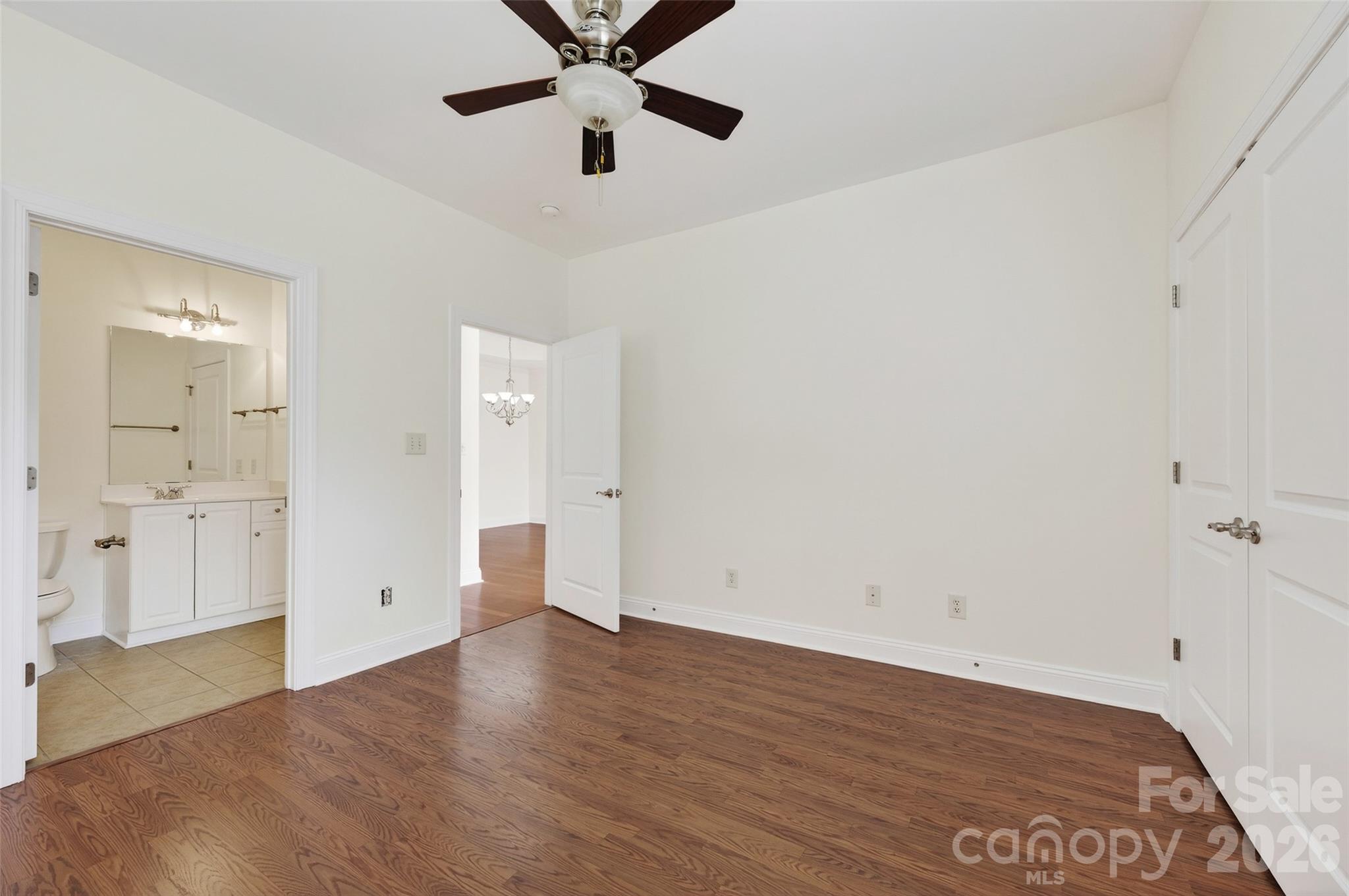 2803 Bellasera Way Matthews, NC 28105 - Photo 22 of 27 an empty room with wooden floor and ceiling fan