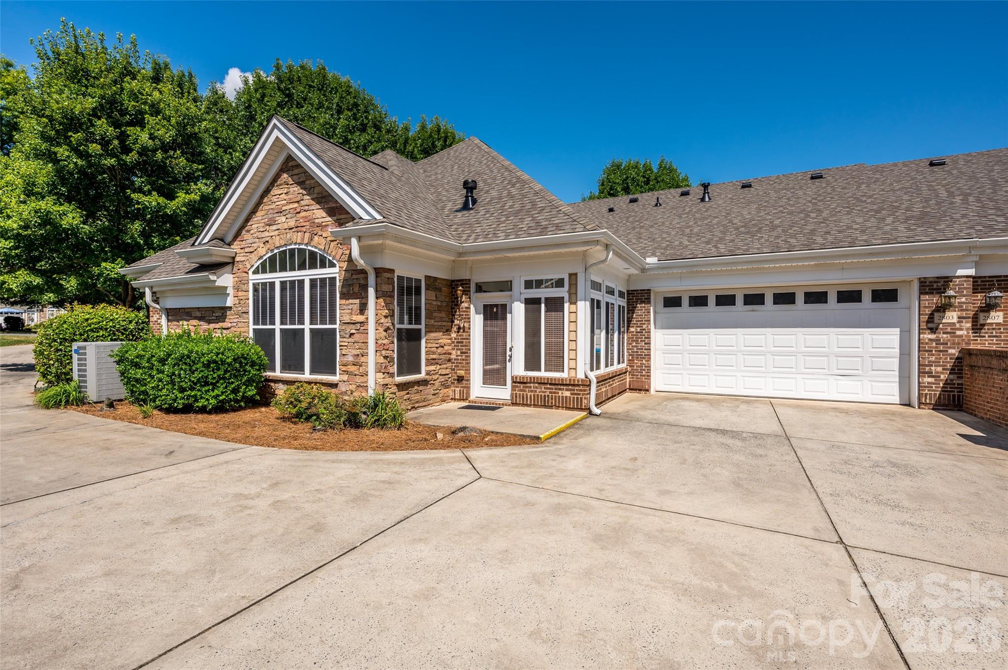 2803 Bellasera Way Matthews, NC 28105 - Photo 25 of 27 a view of a white house with a yard and potted plants