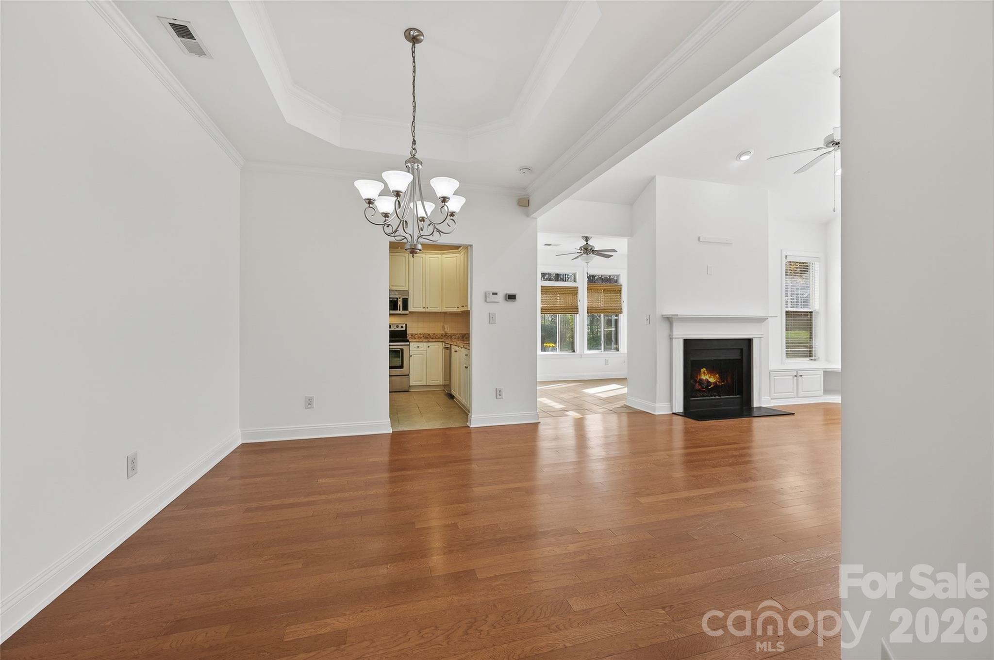 2803 Bellasera Way Matthews, NC 28105 - Photo 4 of 27 a view of a room with wooden floor fireplace and windows