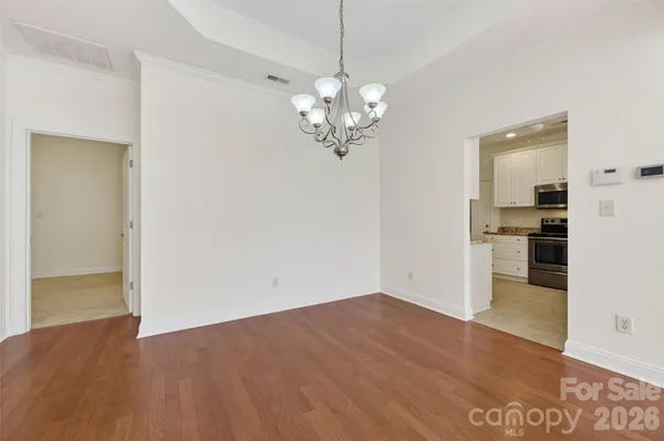 a view of a kitchen with a dishwasher cabinets and wooden floor
