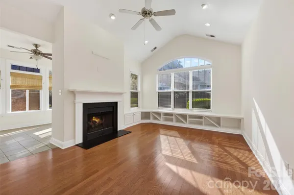 a view of an empty room with a fireplace and a window