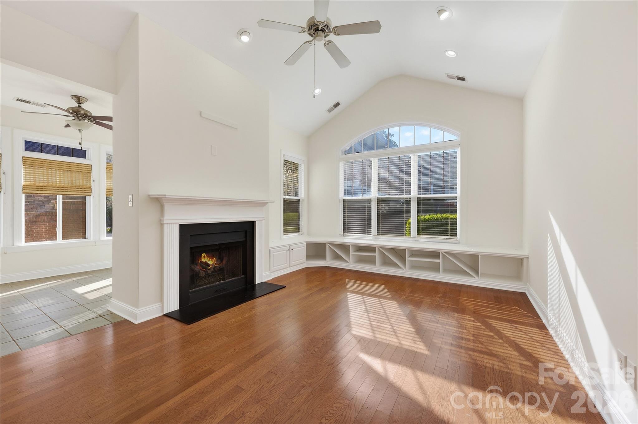 2803 Bellasera Way Matthews, NC 28105 - Photo 8 of 27 a view of an empty room with a fireplace and a window