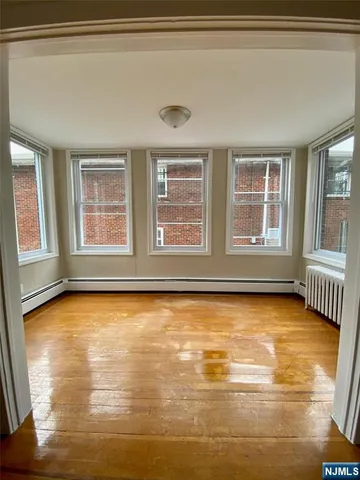 a view of an empty room with glass door
