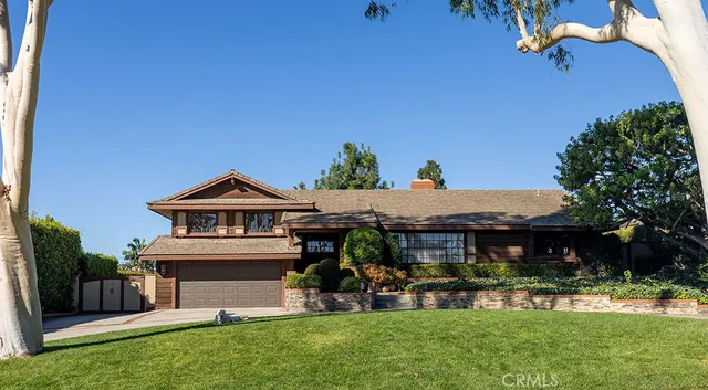 a front view of a house with a yard table and chairs