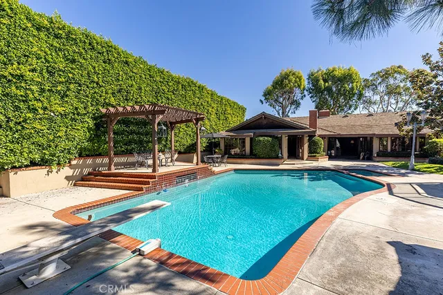 swimming pool view with a seating space