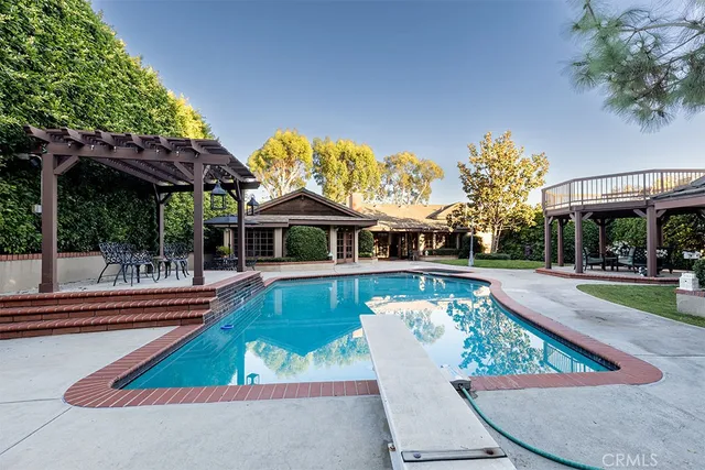 a house with swimming pool in front of it