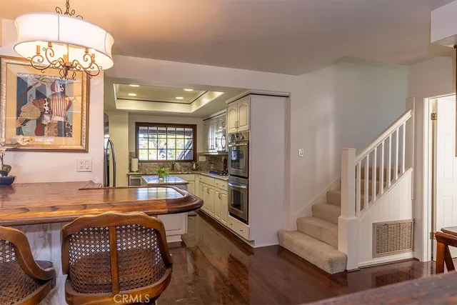 a living room with furniture a table and a chandelier