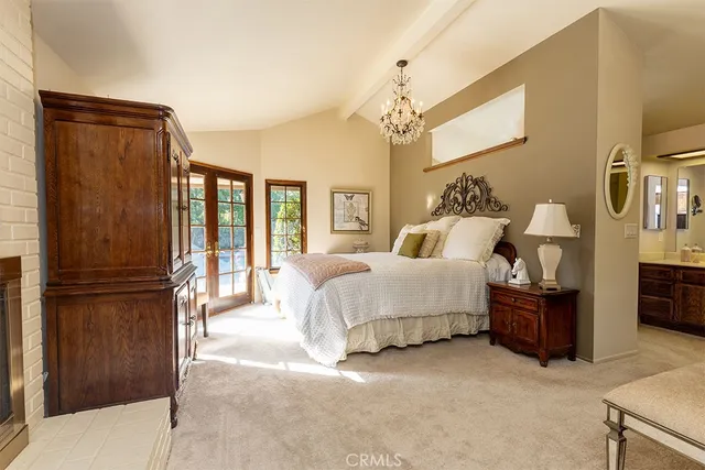 a spacious bedroom with a bed and a chandelier