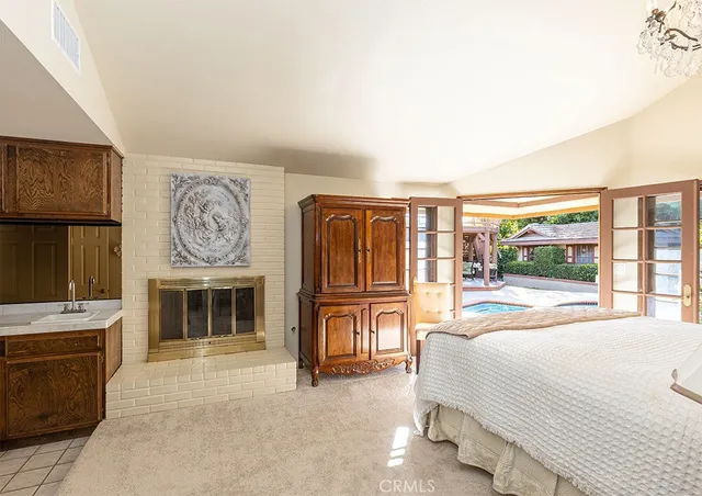 a spacious bedroom with a bed dresser and a large window