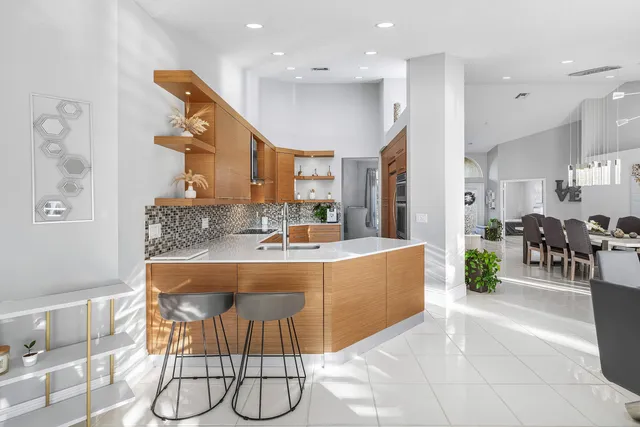 a view of a swimming pool with a patio and a yard