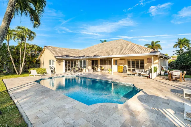 a bathroom with a granite countertop tub sink shower and mirror