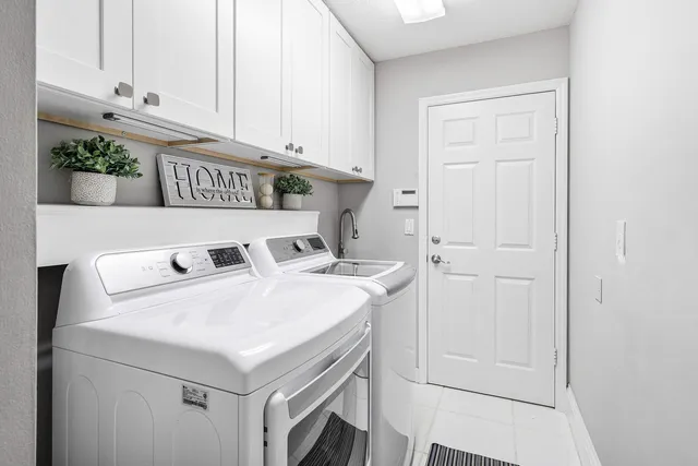 an aerial view of a house with a garden and lake view