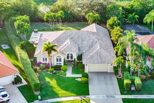 an aerial view of a house with a swimming pool yard and mountain view in back