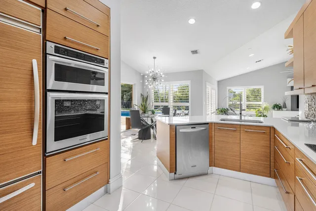 a living room with furniture potted plant and a large window