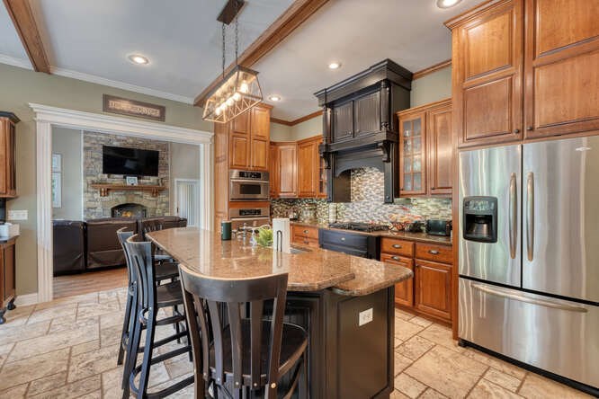 115 Dawsons Lane Murphy, NC 28906 - Photo 11 of 93 a kitchen with stainless steel appliances granite countertop a stove a refrigerator a kitchen island a table and chairs