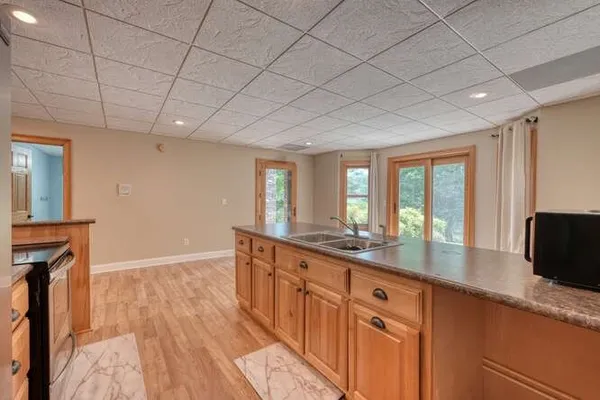 a kitchen with stainless steel appliances granite countertop a sink and a stove