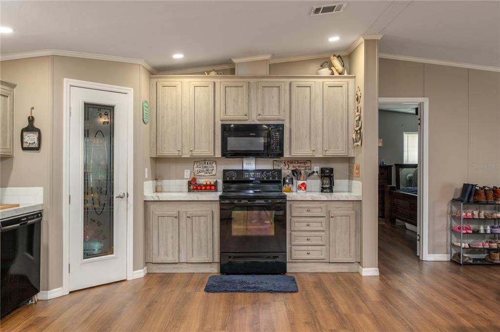 15079 Brahma Road Polk City, FL 33868 - Photo 5 of 40 a kitchen with a refrigerator and a stove top oven