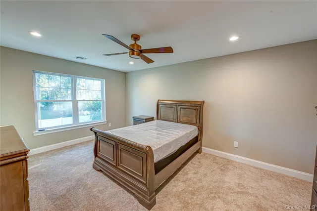 a spacious bedroom with a bed and window