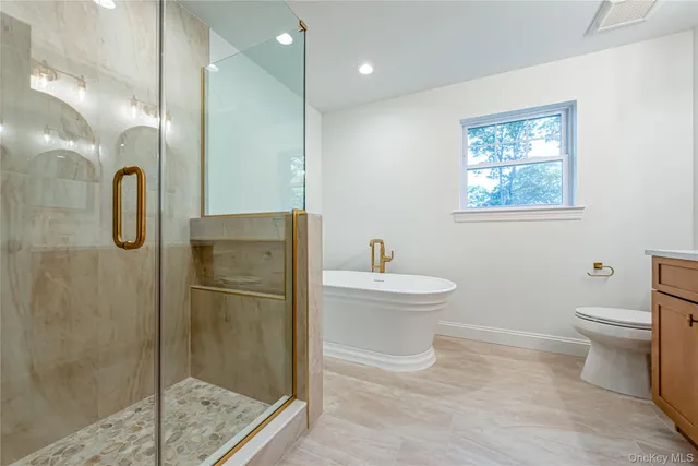 a bathroom with a toilet sink and shower