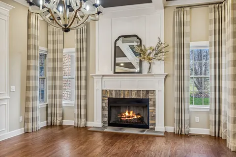 a view of a big room with wooden floor windows and entryway