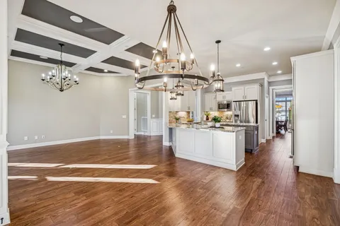 a kitchen with stainless steel appliances granite countertop a stove and cabinets