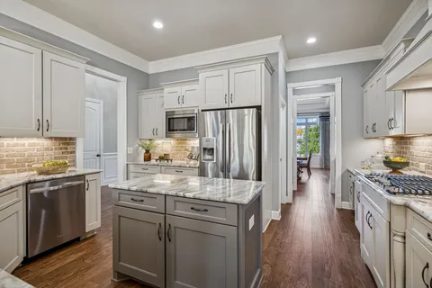 a kitchen with stainless steel appliances granite countertop a sink stove and cabinets