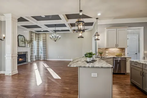a bathroom with a granite countertop sink a mirror and vanity
