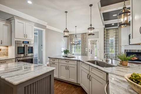 a en suite bathroom with a granite countertop tub and a large mirror