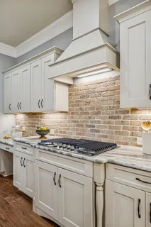 a bathroom with a granite countertop sink toilet mirror and shower