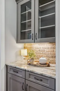 a bathroom with a granite countertop sink a toilet and bathtub