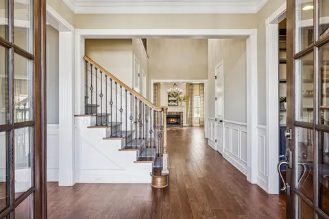a view of an entryway with wooden floor and stairs