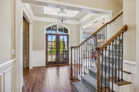 a view of entryway and hall with wooden floor